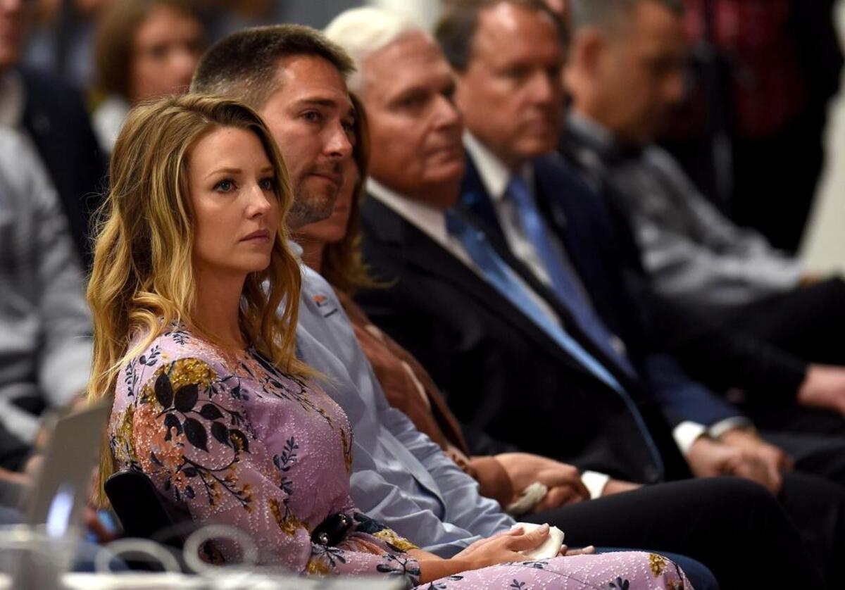 Amy Earnhardt listens as her husband, NASCAR driver Dale Earnhardt Jr., announce his retirement in Concord on Tuesday.