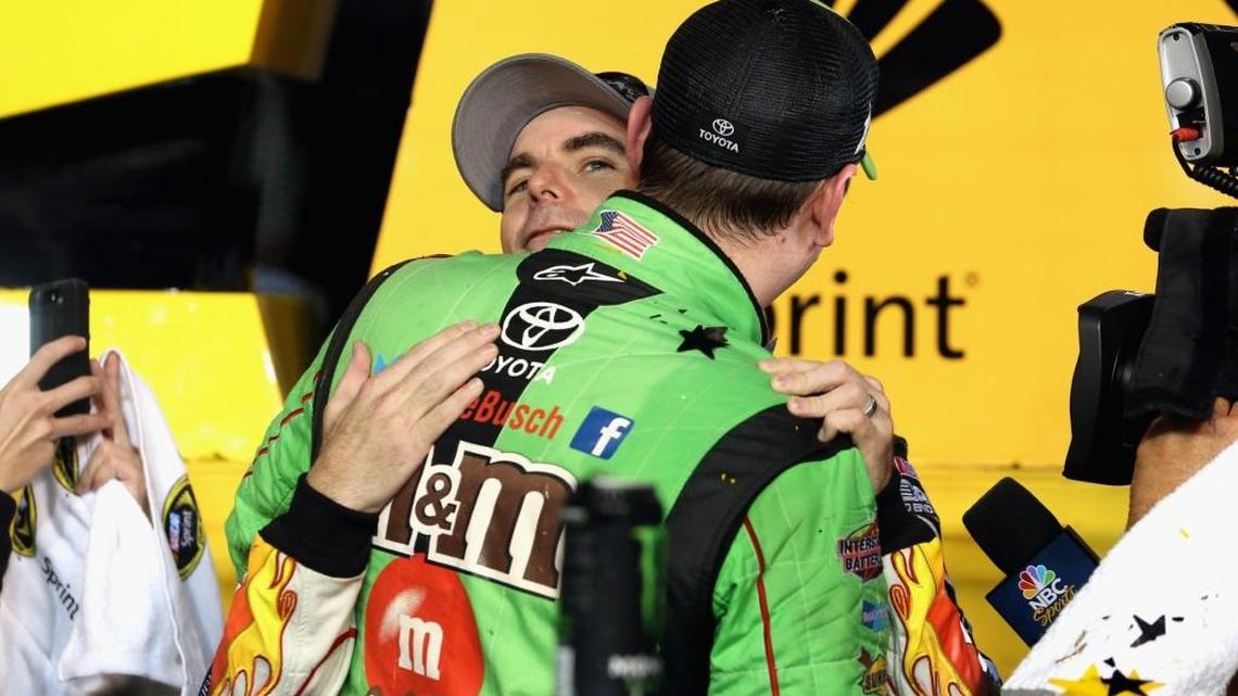 Kyle Busch celebrates on Sunday with Jeff Gordon after Busch won the championship and the NASCAR Sprint Cup Series Ford EcoBoost 400 at Homestead-Miami Speedway.