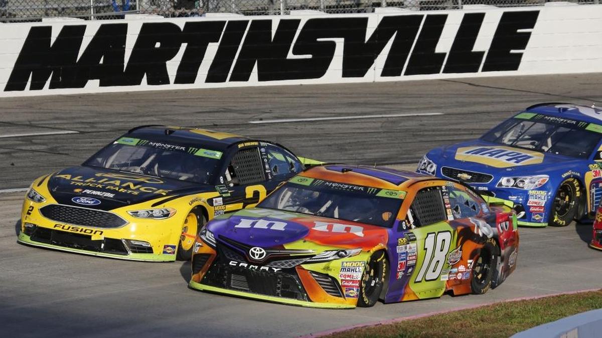 Kyle Busch’s win at Martinsville officially sends him to Homestead to race for a Cup Series championship. Above, Busch (18) and Brad Keselowski (2) lead the field on a restart during the third stage of Sunday’s race.