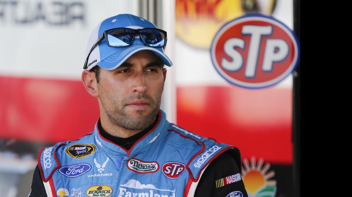 
Aric Almirola stands in a garage during a NASCAR Sprint Cup practice session at Daytona International Speedway, Friday, July 3, 2015, in Daytona Beach, Fla. 
