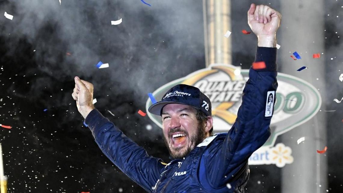 Martin Truex Jr. raises his arms in celebration following his victory in Saturday’s Quake State 400 at Kentucky Speedway in Sparta, Ky.