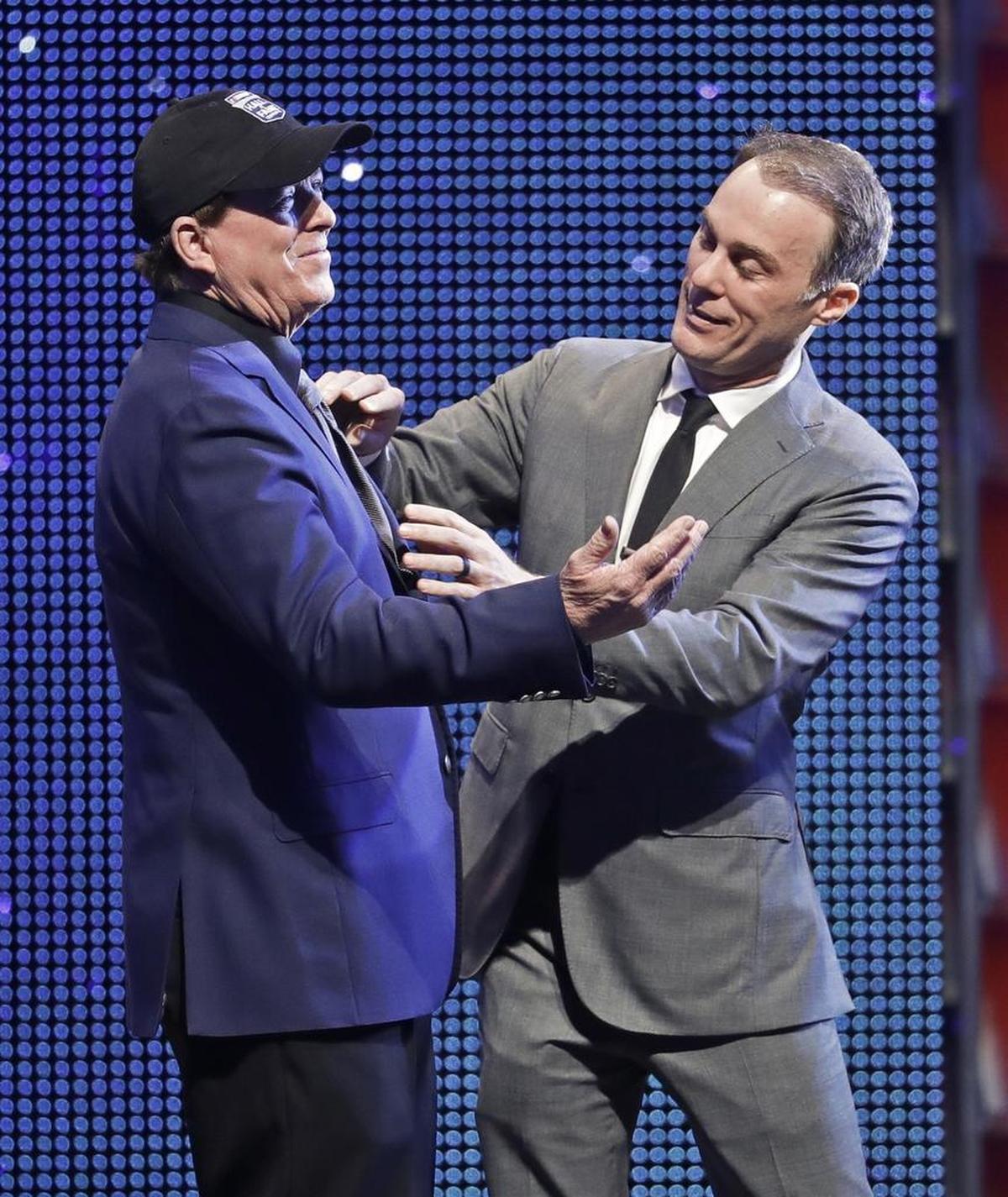 2014 NASCAR Cup series champion Kevin Harvick, right, jokes with Ron Hornaday Jr. as Hornaday is inducted into NASCAR's Hall of Fame Friday.
