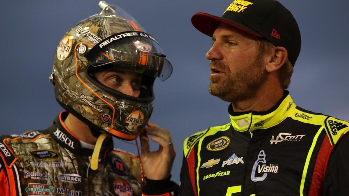 Clint Bowyer (right) talks with future Stewart-Haas Racing teammate Kevin Harvick last week at Charlotte Motor Speedway.
