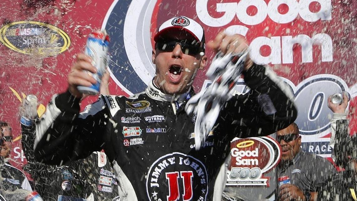 Kevin Harvick celebrates in victory lane after winning Sunday’s NASCAR Sprint Cup Series auto race at Phoenix International Raceway.