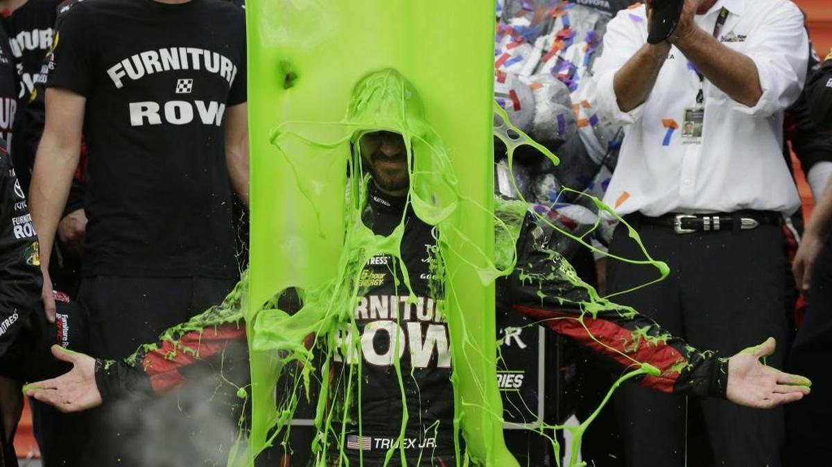 Martin Truex Jr., celebrates with his crew in Victory Lane after winning Sunday’s NASCAR Cup Monster Energy Series auto race at Chicagoland Speedway in Joliet, Ill.