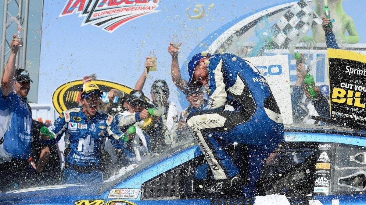 Dale Earnhardt Jr. (88) is showered with soda in Victory Lane after winning the Talladega 500 in 2015.