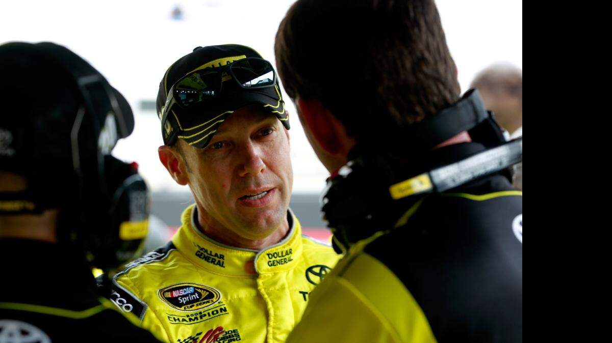 
Matt Kenseth talks to crew members during qualifying for the NASCAR Sprint Cup Series Food City 500 at Bristol Motor Speedway on Friday, April 17, 2015 in Bristol, Tenn. Joe Gibbs Racing driver Kenseth will start from the pole in Sunday’s race with teammates Carl Edwards qualifying third and Denny Hamlin fifth. 
