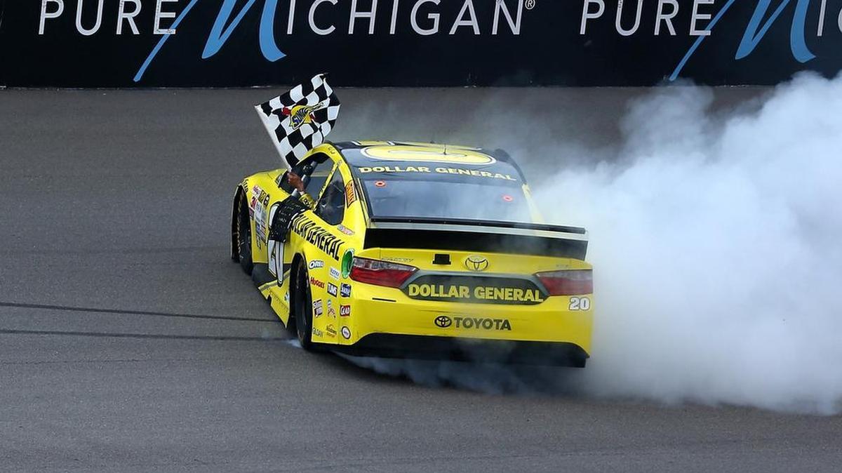 
Matt Kenseth, driver of the #20 Dollar General Toyota, celebrates with a burnout after winning the NASCAR Sprint Cup Series Pure Michigan 400 at Michigan International Speedway on August 16, 2015 in Brooklyn, Michigan. (Photo by Sarah Crabill/Getty Images)
