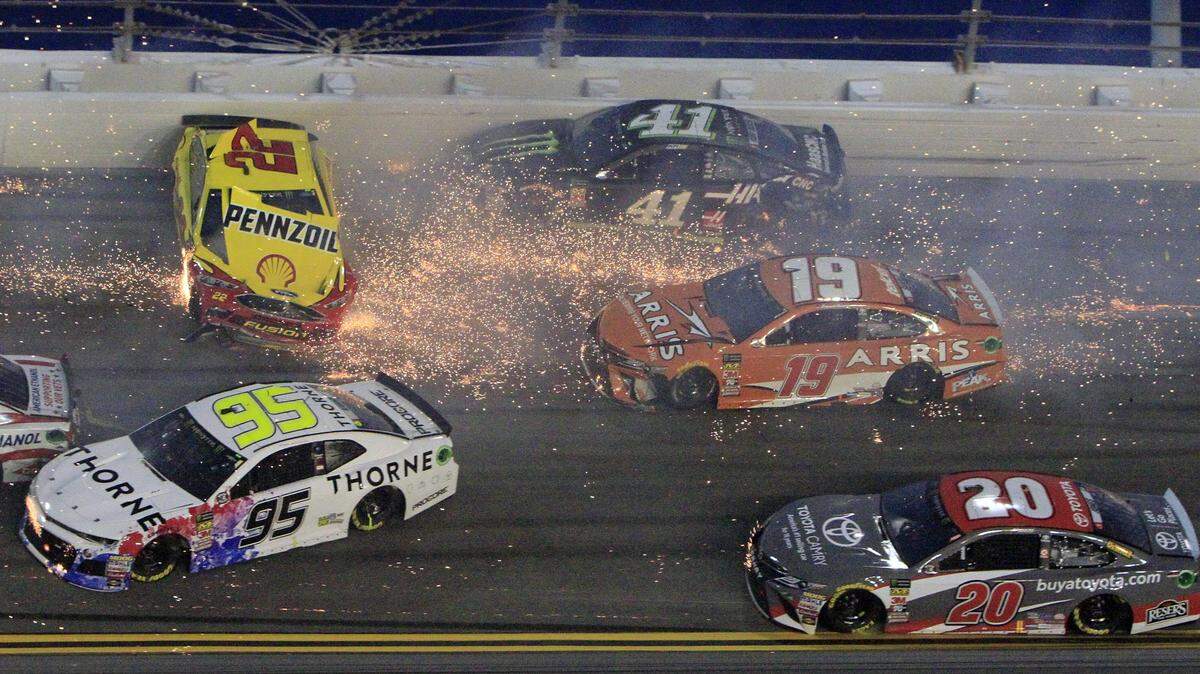 Joey Logano (22) hits the wall as he is involved in a multi-car crash also involving Kasey Kahne (95), Kurt Busch (41), Daniel Suarez (19), Erik Jones (20) and others during the NASCAR Cup Series auto race at Daytona International Speedway, Saturday, July 7, 2018, in Daytona Beach, Fla. (AP Photo/Ron Sander)