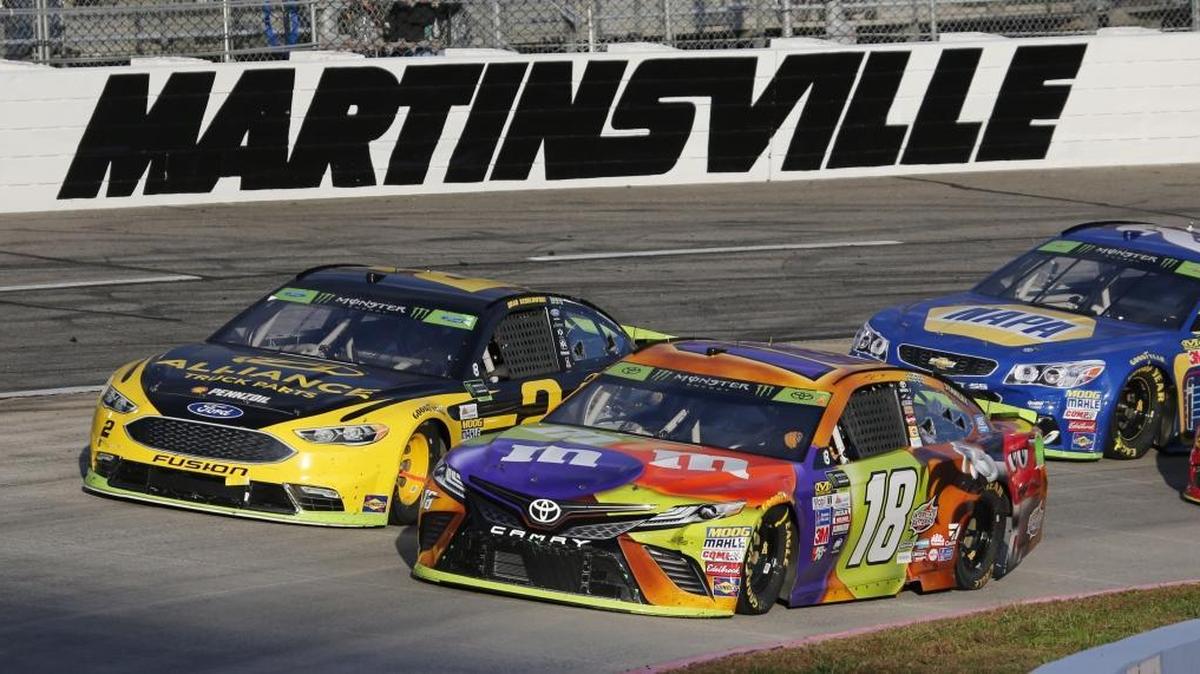 Kyle Busch (18) and Brad Keselowski (2) lead the field on a restart during the third stage of last fall’s NASCAR Cup series auto race at Martinsville Speedway.