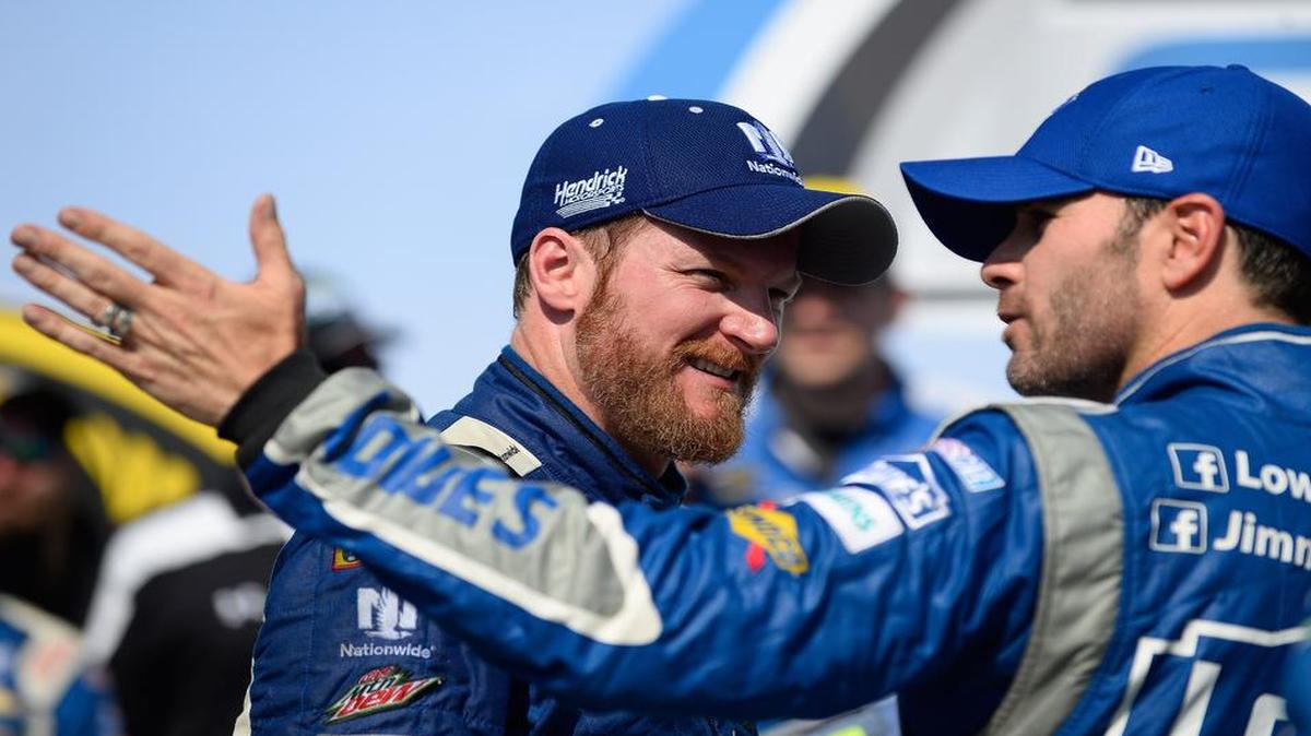 
Dale Earnhardt Jr., left, talks with Jimmie Johnson in Victory Lane after the Talladega 500 NASCAR Sprint Cup race at Talladega on Sunday. Some fans have theorized Johnson didn’t do enough to try to pass Earnhardt, but Johnson disagrees. 
