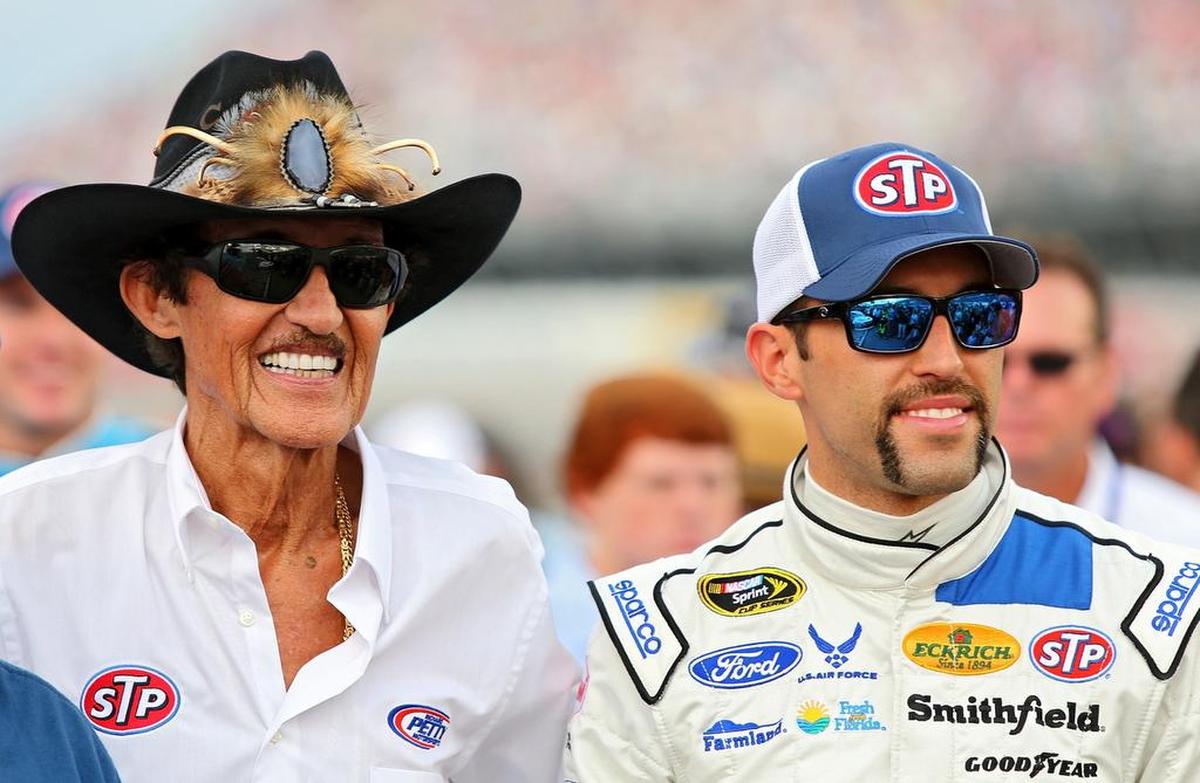 Aric Almirola, driver of the #43 STP Ford, right, and team owner Richard Petty take part in pre-race ceremonies for the NASCAR Sprint Cup Series Bojangles’ Southern 500 at Darlington Raceway on September 6, 2015 in Darlington, South Carolina. (Photo by Jerry Markland/Getty Images)