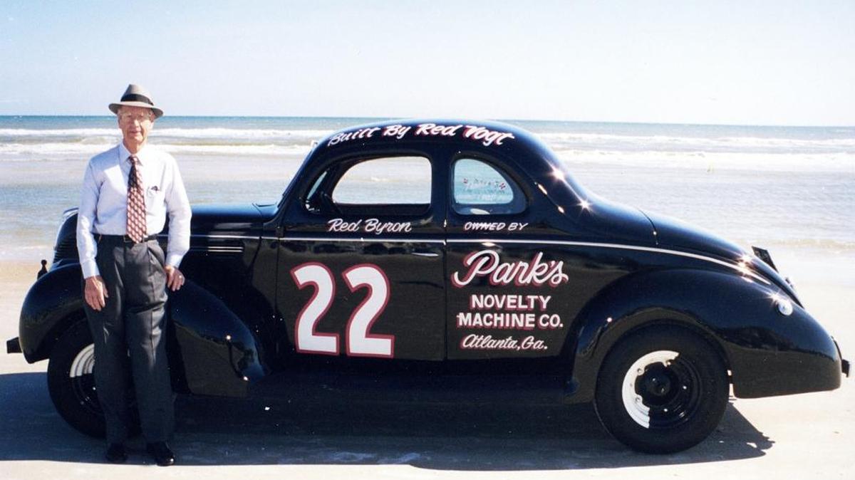 In a photo from the mid-1990s, Raymond Parks stands next to a replica of one of the NASCAR Modified Stock cars that Red Byron drove for him in the late-1940s.