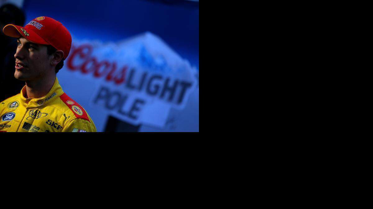 
Sprint Cup driver Joey Logano, left, stands in the garage area after winning the pole for Sunday's NASCAR Sprint Cup race at the Martinsville Speedway in Martinsville, Va., Friday, March 27, 2015. The pole is Logano’s second of the season, 10
th
 of his season and first at Martinsville.
