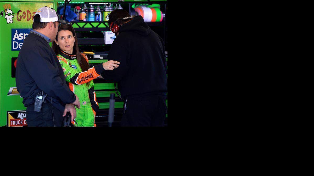 
Stewart-Haas competition director Greg Zipadelli talks with NASCAR Sprint Cup Series driver Danica Patrick after her practice session wreck at Daytona International Speedway in Daytona Beach, Fla., on Wednesday. The damage to Patrick’s car was bad enough to force her to a backup and send her to the back of the field for her Daytona Duel qualifying race Thursday. 
