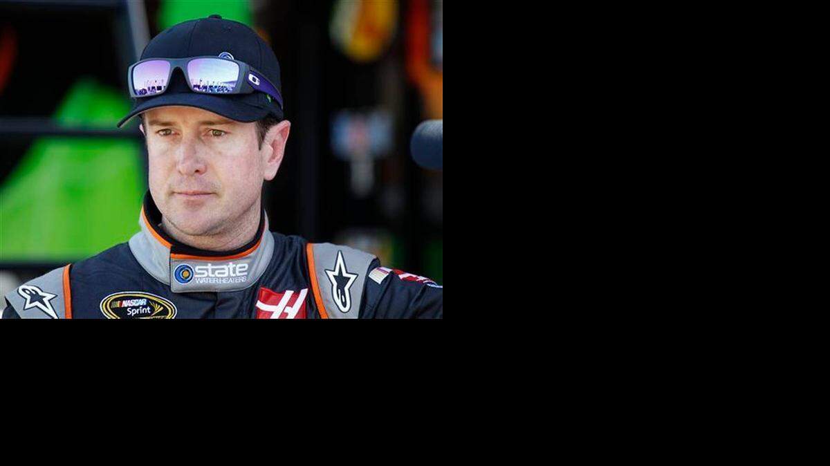 
Kurt Busch looks from the garage after practice for the NASCAR Bank of America Sprint Cup series auto race at Charlotte Motor Speedway on Oct. 9, 2014. NASCAR lifted its suspension of Kurt Busch on Wednesday and ruled the former champion can compete in the title Chase should he qualify. Busch missed the first three races of the season when NASCAR suspended him over allegations of domestic assault on his ex-girlfriend.

