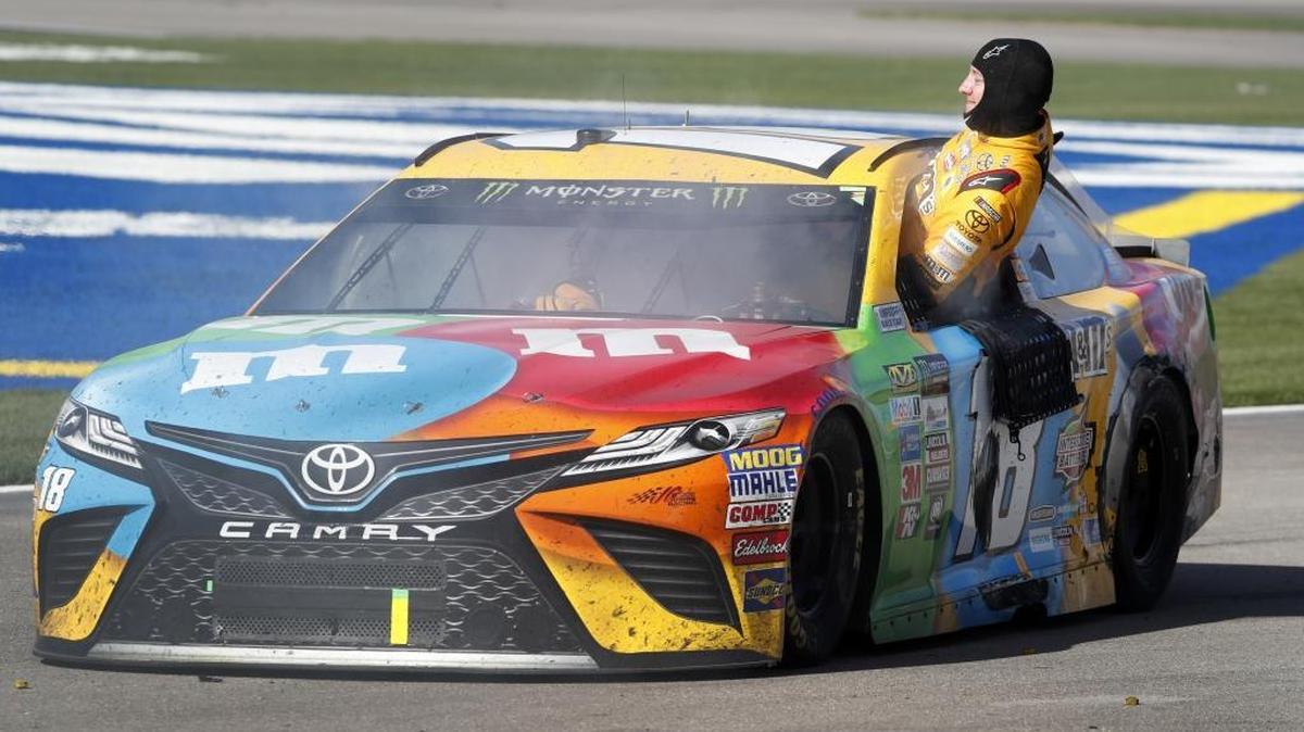 Kyle Busch (18) climbs out of his smoking car in pit lane at the end of Sunday’s NASCAR Cup Series auto race at Las Vegas Motor Speedway.