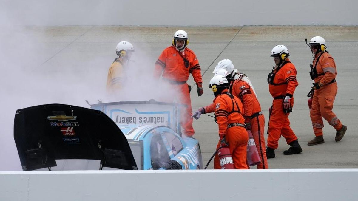 Rescue workers go to Danica Patrick’s car after she wrecked during practice Friday at Dover International Speedway.