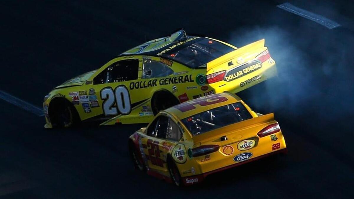 
Joey Logano (22) makes contact with Matt Kenseth (20) during Sunday’s NASCAR Sprint Cup Series Hollywood Casino 400 at Kansas Speedway.

