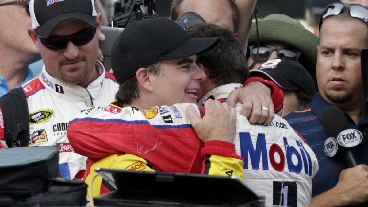 Jeff Gordon, center left, hugs Tony Stewart following the Brickyard 400 NASCAR Sprint Cup auto race at Indianapolis Motor Speedway in Indianapolis, Sunday, July 24, 2016.