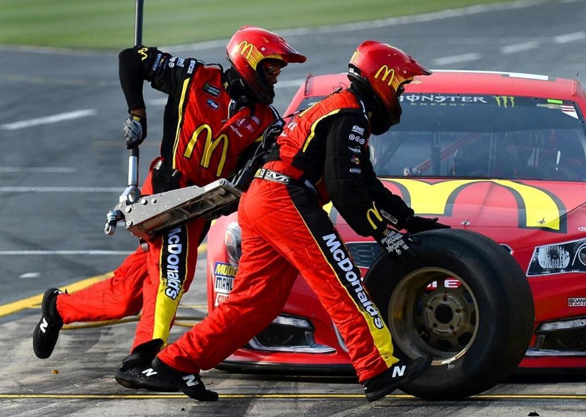 NASCAR jackman Richie Williams, left, races around the team’s car during the NASCAR All-Star Race qualifying at Charlotte Motor Speedway on Friday. Williams, a former football player at Appalachian State, works for driver Jamie McMurray’s team.
