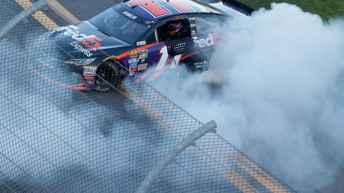 Denny Hamlin does a celebratory spin-out after winning the Daytona 500.
