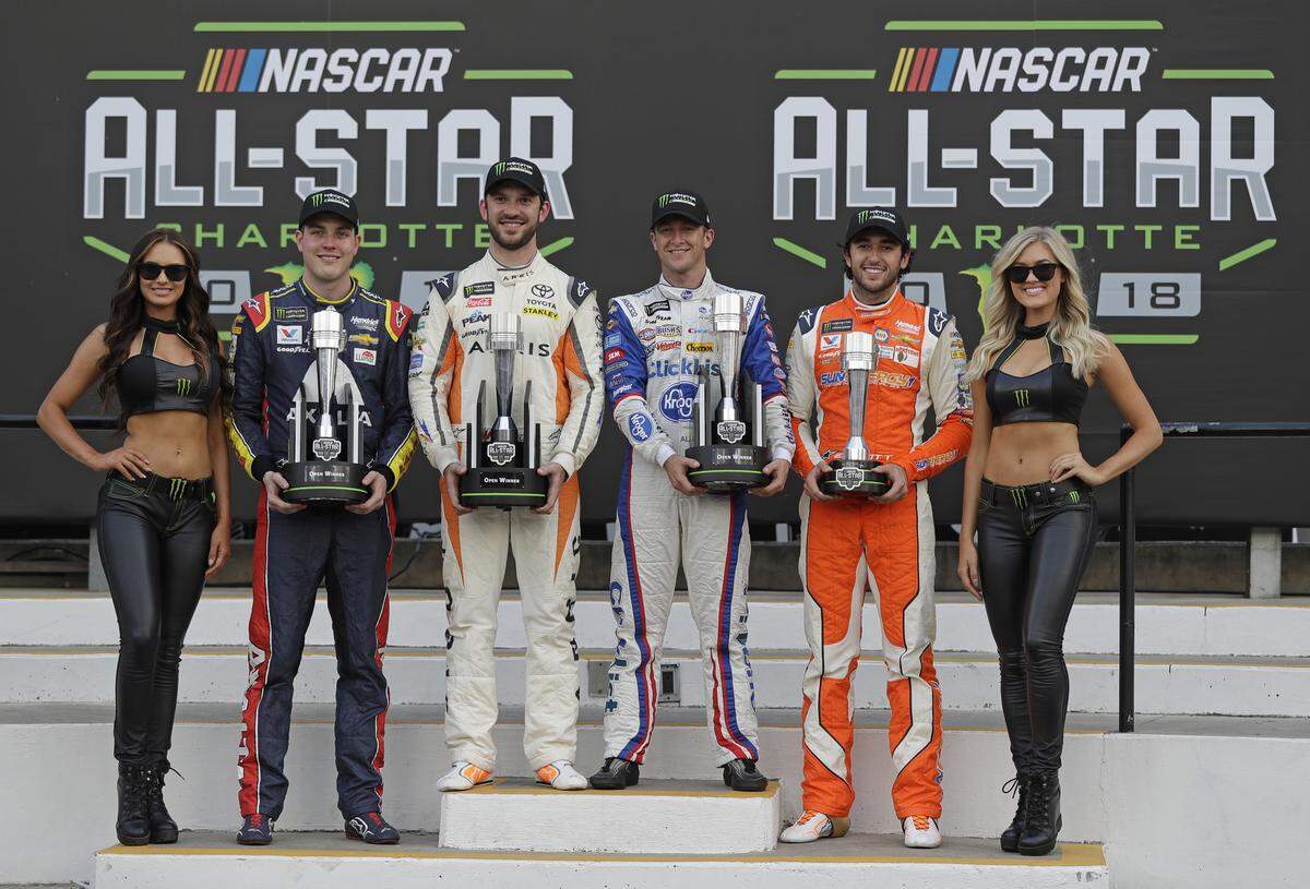 Alex Bowman, Daniel Suarez, AJ Allmendinger and Chase Elliott, from second from left, pose with trophies in Victory lane after the NASCAR Open auto race at Charlotte Motor Speedway in Concord, N.C., Saturday, May 19, 2018. Bowman, Suarez and Allmendinger won the three segments of the race. Chase Elliott won the fan vote. All four drivers advance to the All-Star race. (AP Photo/Chuck Burton)