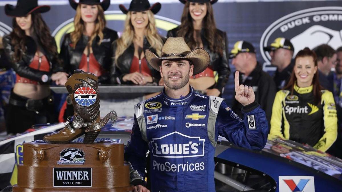 Jimmie Johnson poses for photos in Victory Lane after winning the NASCAR Sprint Cup series race at Texas Motor Speedway in Fort Worth.