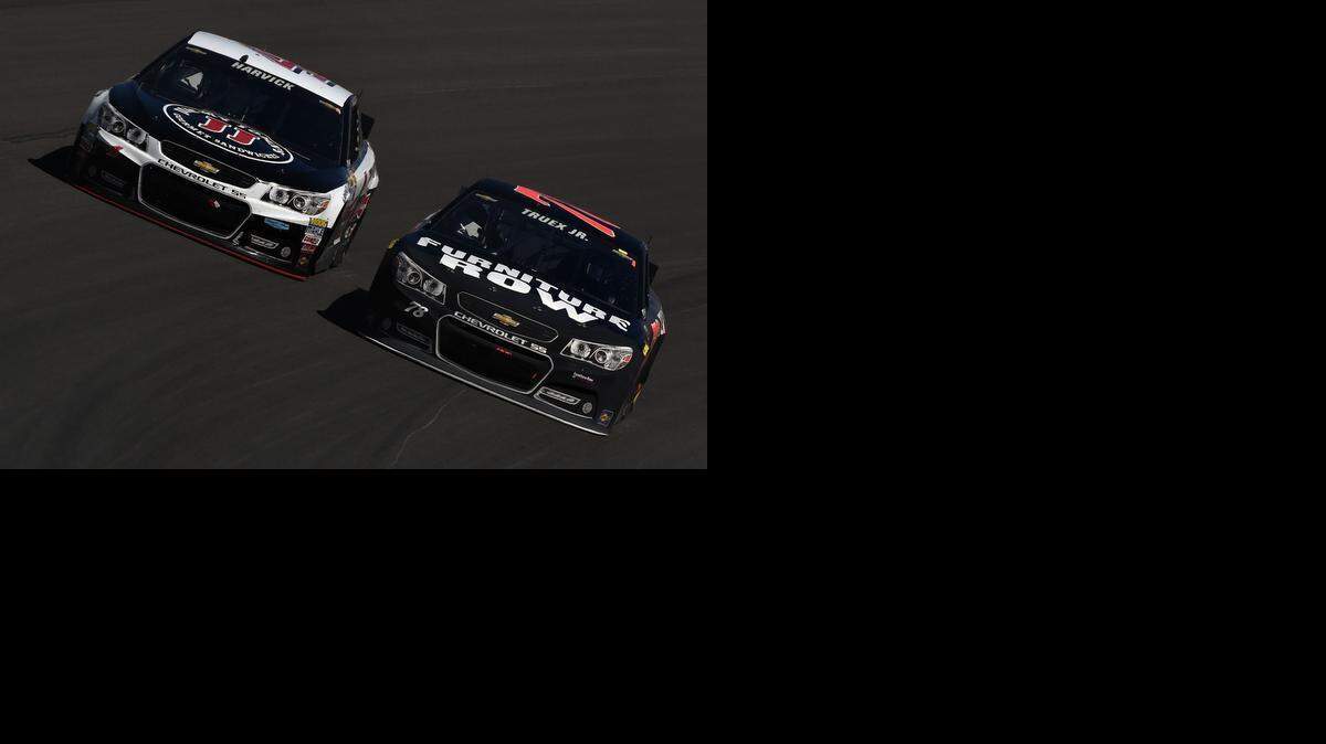 
Kevin Harvick and Martin Truex Jr. race during the NASCAR Sprint Cup Series Kobalt 400 at Las Vegas Motor Speedway on Sunday in Las Vegas.
