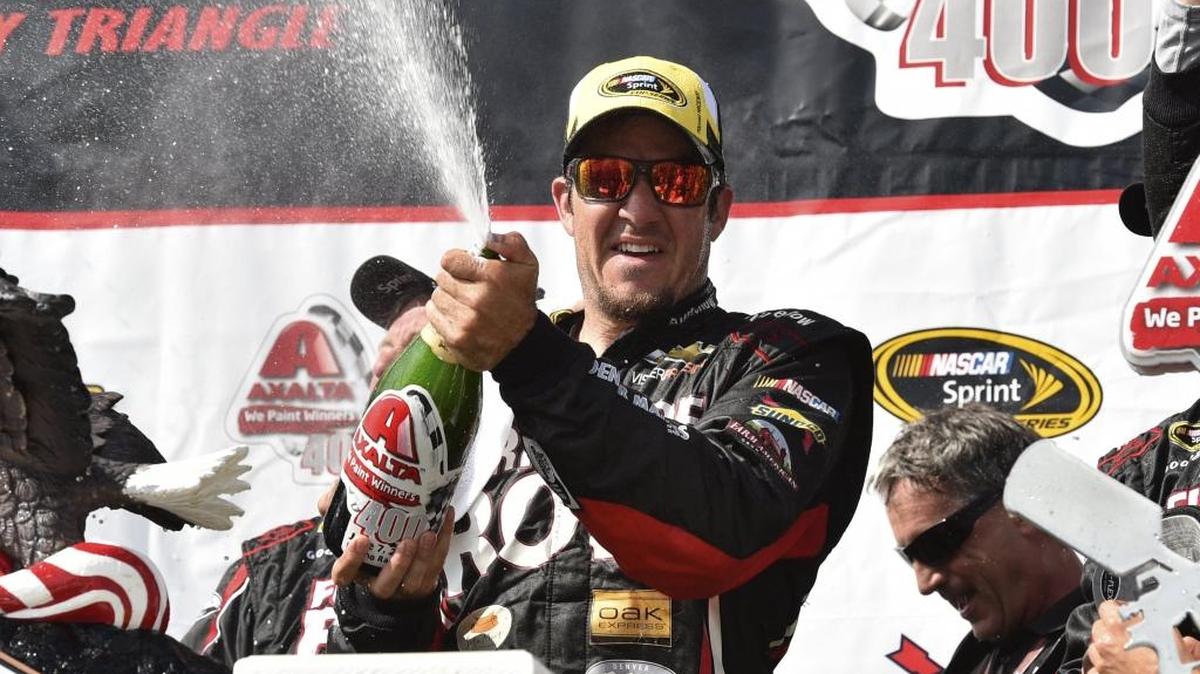 Martin Truex Jr. celebrates in Victory Lane at Pocono Raceway after winning the 2015 Sprint Cup series race at the track.