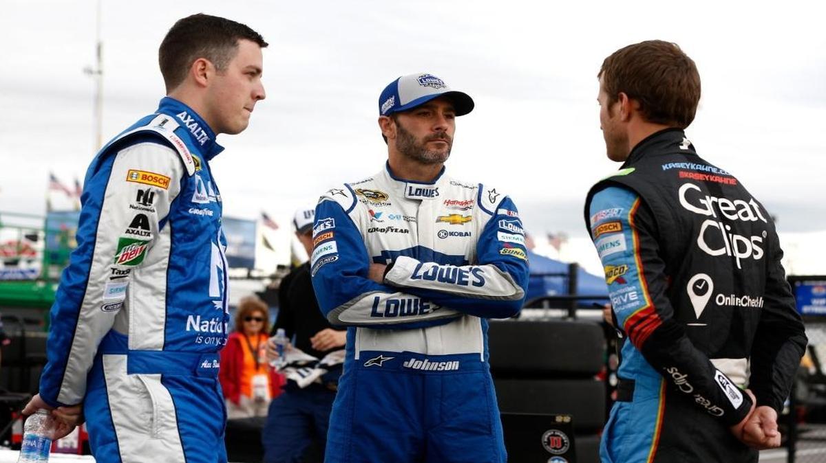 Jimmie Johnson (center), talking with Hendrick Motorsports teammates Alex Bowman (left) and Kasey Kahne (right), wasn’t penalized after his car failed post-race inspection at Chicagoland Speedway.