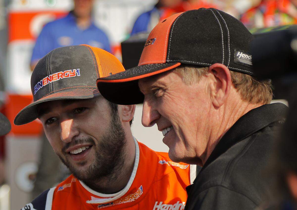 Chase Elliott, left, and his father Bill Elliott answer questions during an interview after Chase won a NASCAR Cup Series auto race, Sunday, Aug. 5, 2018, in Watkins Glen, N.Y. (AP Photo/Julie Jacobson)