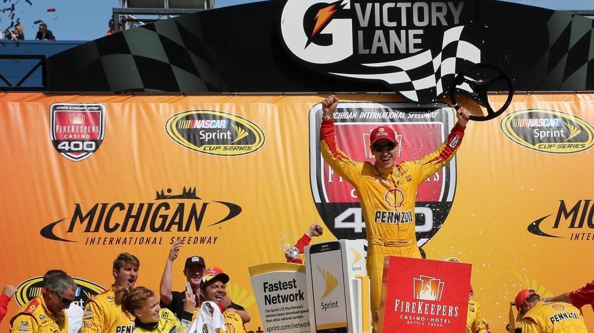 Joey Logano, driver of the #22 Shell Pennzoil Ford, celebrates in victory lane after winning the NASCAR Sprint Cup Series FireKeepers Casino 400 at Michigan International Speedway on June 12, 2016 in Brooklyn, Michigan.
