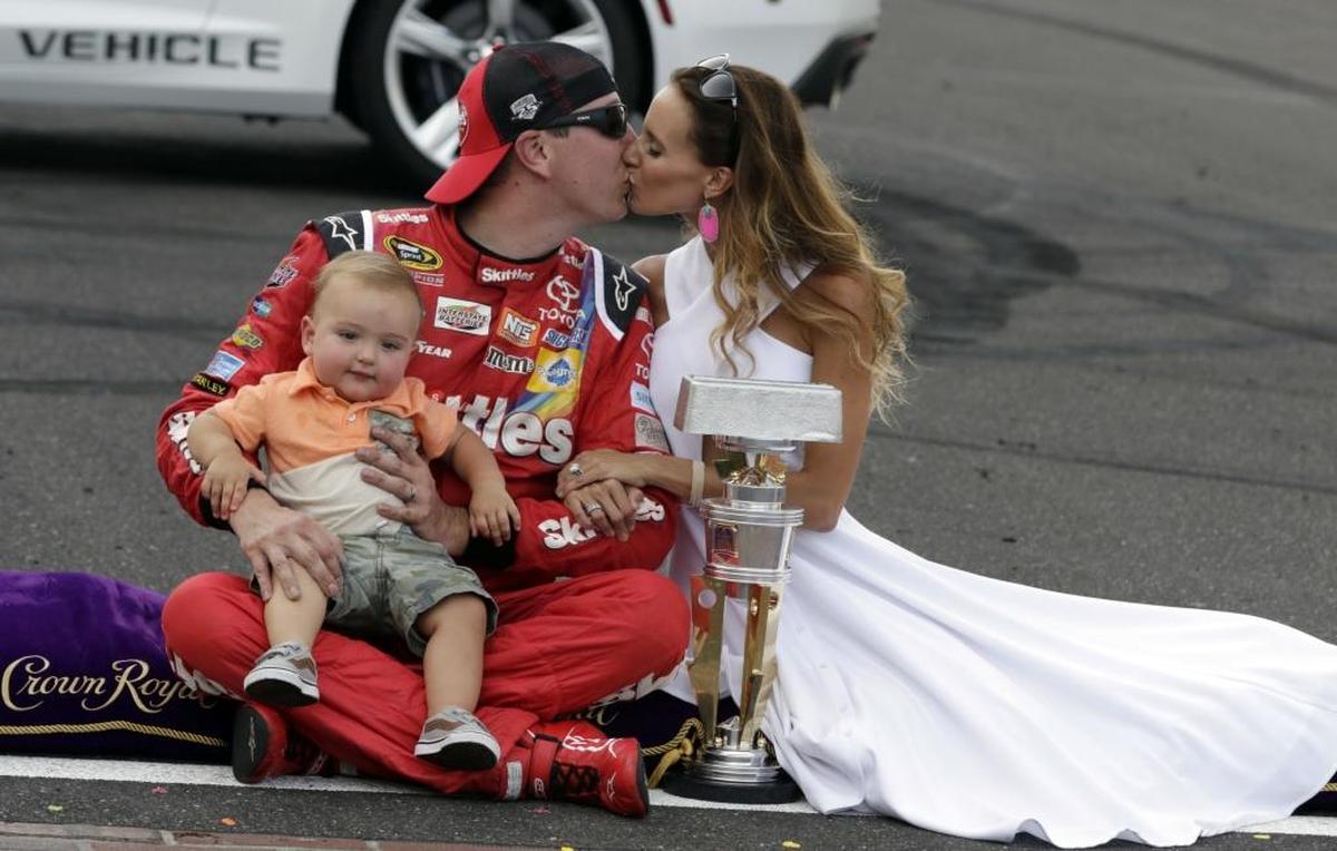 Kyle Busch kisses his wife Samantha as he holds their son Brexton after wining last July’s Brickyard 400 Cup Series race at Indianapolis Motor Speedway.
