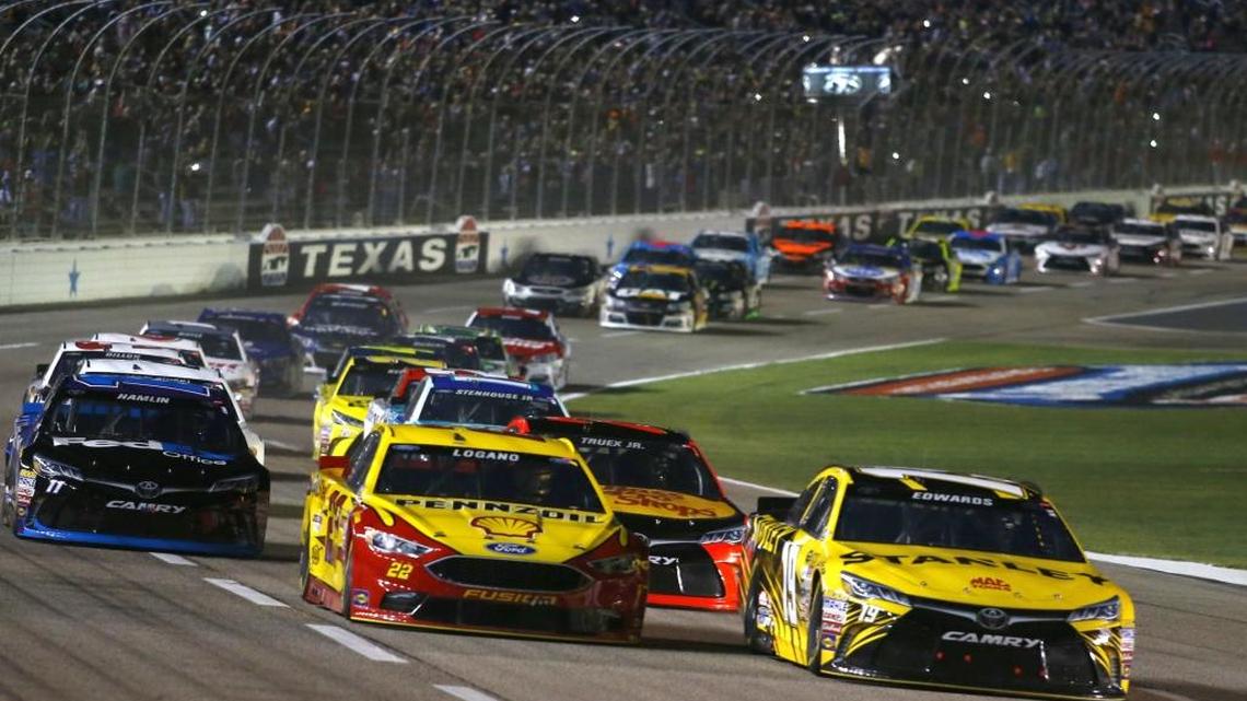 Carl Edwards, right, and Joey Logano, center, are at the front of the pack on the first lap of the NASCAR Sprint Cup Series race at Texas Motor Speedway in Fort Worth, Texas, Saturday. The race start was delayed by rain and was not over in time for this edition. For NASCAR news go to nando.com/sports.