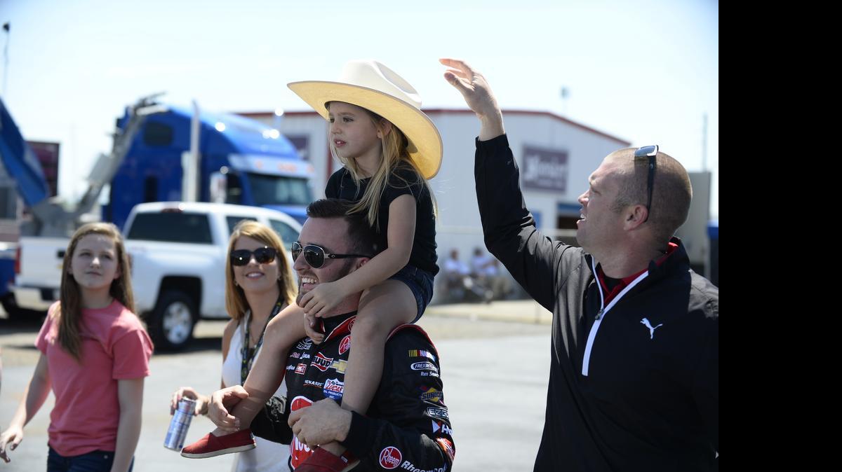 
Austin Dillon gives a piggy back ride to Riyan Shipplett, the daughter of a crew member, during qualifying for the NASCAR Sprint Cup Series auto race at Talladega Superspeedway, Saturday, May 2, 2015, in Talladega, Ala. 
