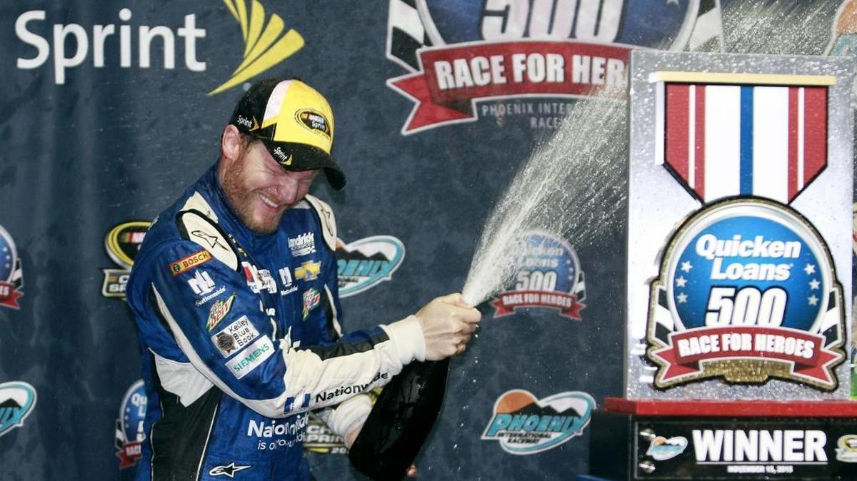 Dale Earnhardt Jr. celebrates after winning Sunday’s NASCAR Sprint Cup Series auto race at Phoenix International Raceway. Earnhardt was leading on lap 219 when the race was called due to rain.