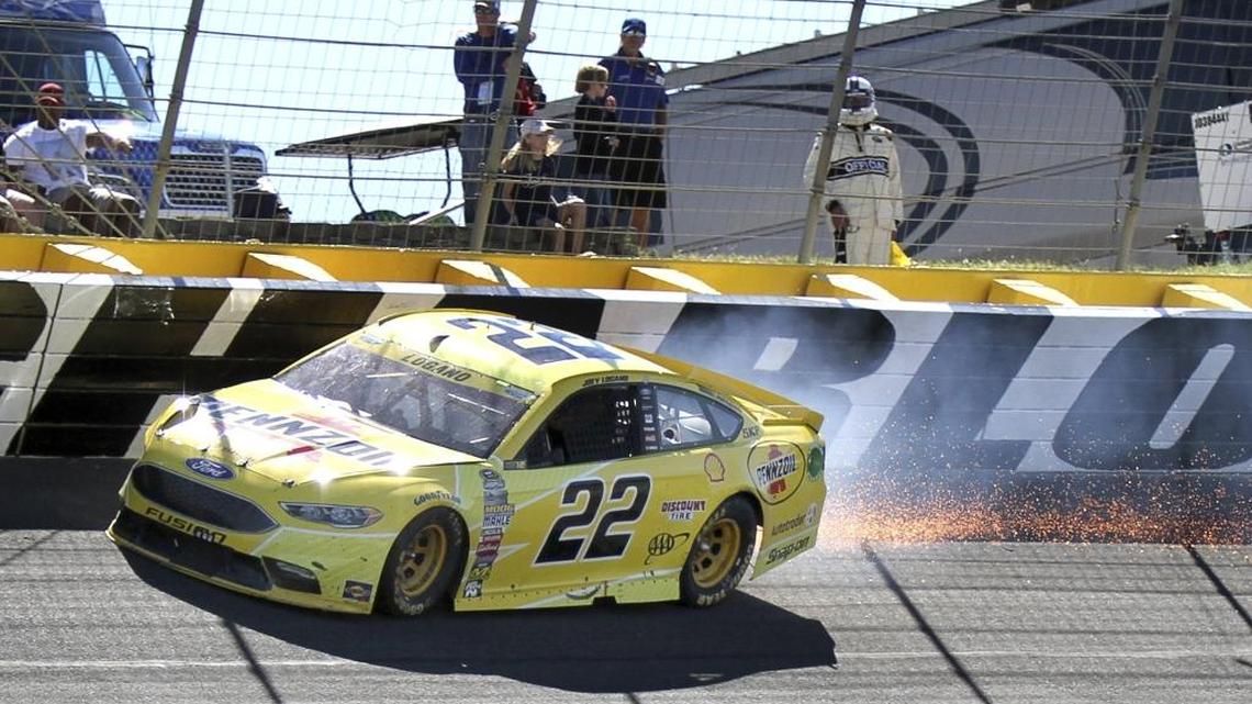 Joey Logano (22) hits the wall in Turn 2 at Charlotte on Sunday in the Bank of America 500. The hit cost him time behind the wall and put his Chase hopes in jeopardy.