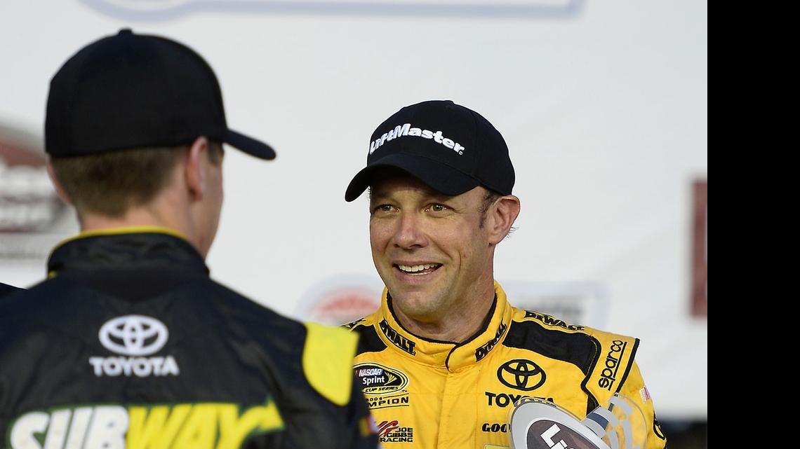 
NASCAR Sprint Cup Series driver Matt Kenseth, right, is congratulated by Joe Gibbs Racing teammate Carl Edwards, left, after Kenseth won the LiftMaster Pole Night trophy on Thursday, May 21, 2015 at Charlotte Motor Speedway in Concord. Kenseth will start from the pole for Sunday’s Coca-Cola 600.
