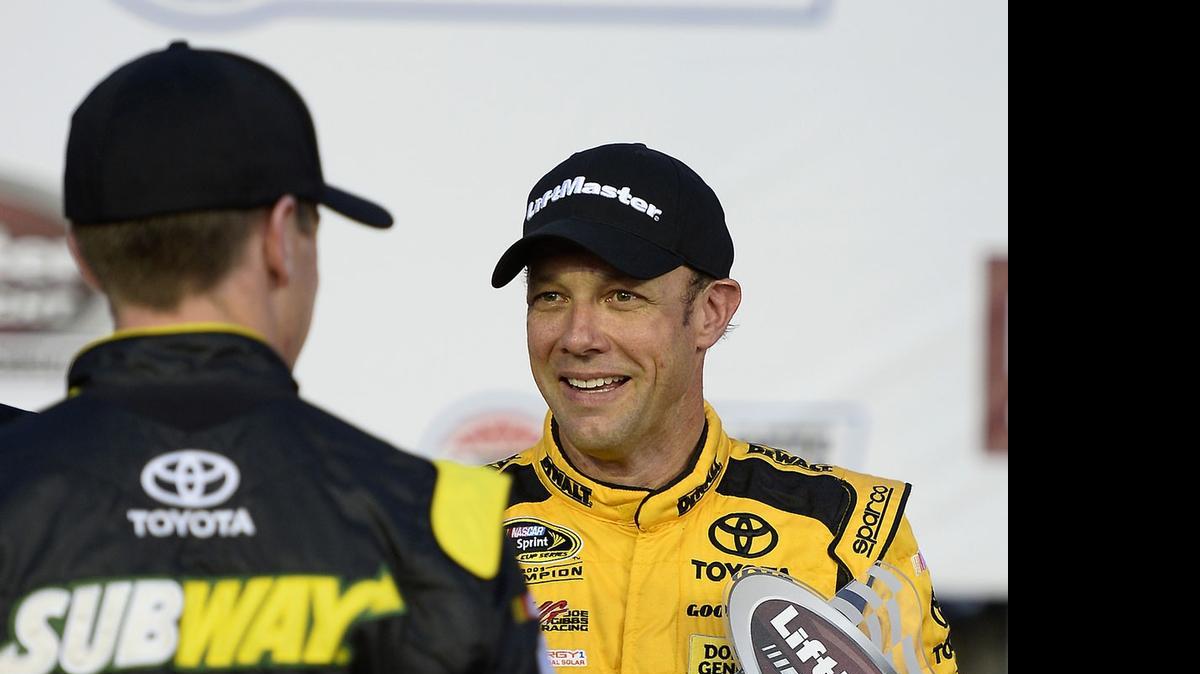 
NASCAR Sprint Cup Series driver Matt Kenseth, right, is congratulated by Joe Gibbs Racing teammate Carl Edwards, left, after Kenseth won the LiftMaster Pole Night trophy on Thursday, May 21, 2015 at Charlotte Motor Speedway in Concord. Kenseth will start from the pole for Sunday’s Coca-Cola 600.

