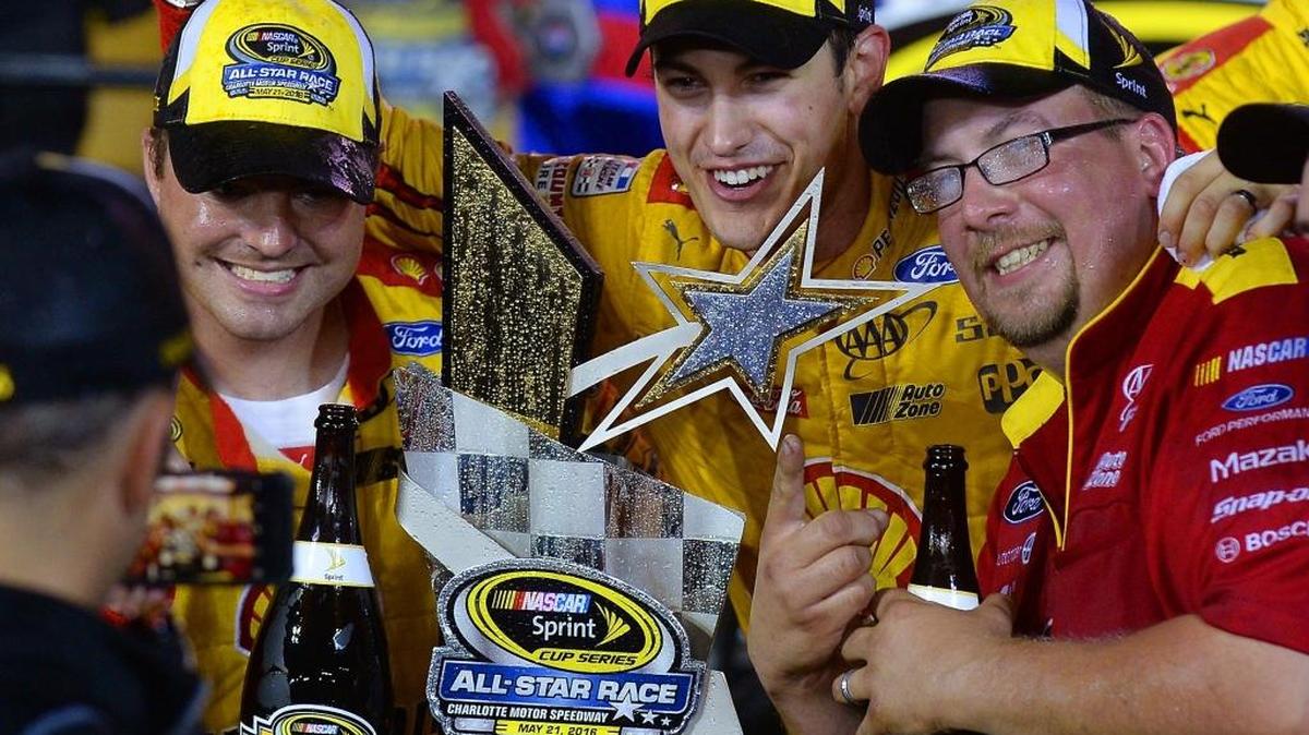 Joey Logano (center) celebrates his Sprint All-Star race victory with crew members Saturday night.