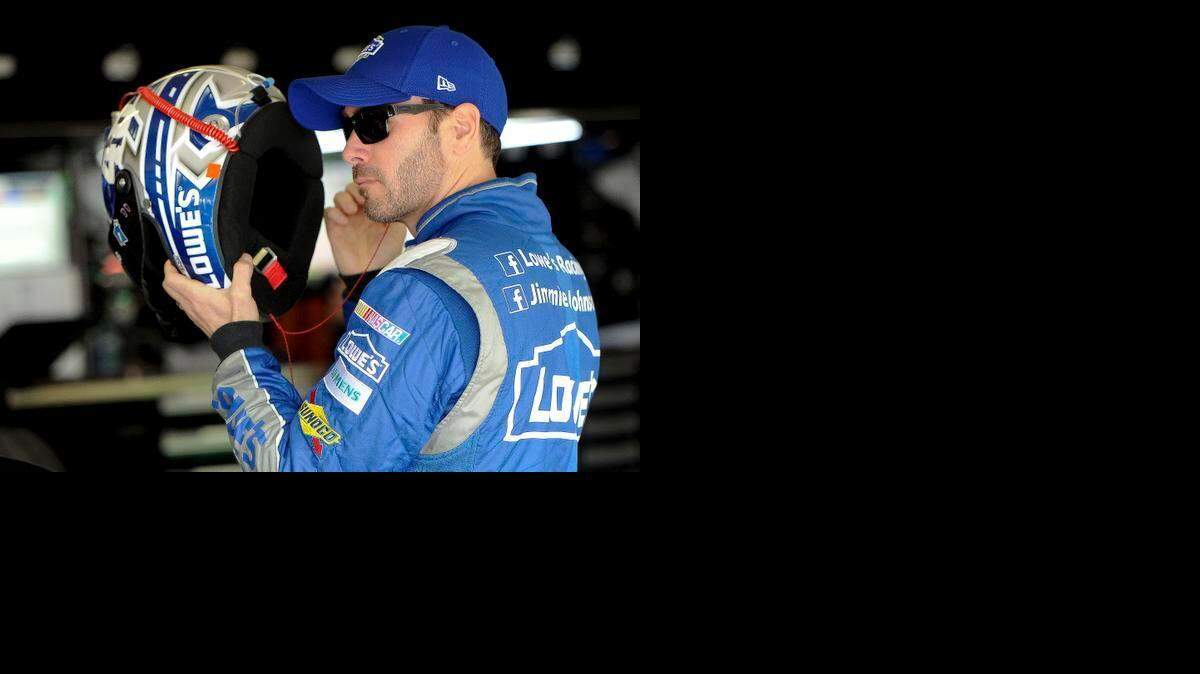
Driver Jimmie Johnson get ready for a practice session for Sunday's NASCAR Sprint Cup Series auto race, Saturday, Feb. 28, 2015, in Hampton, Ga.
