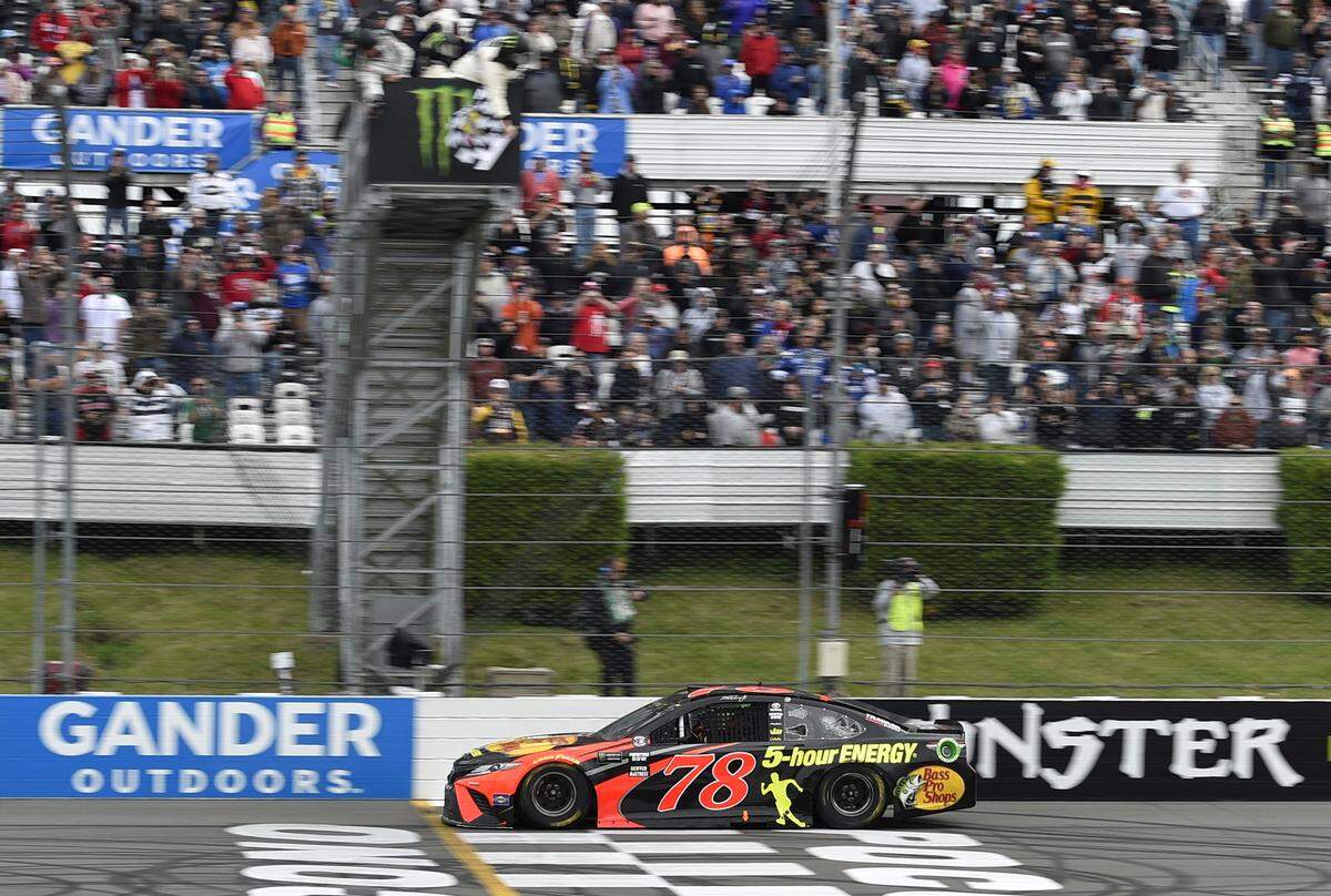 Martin Truex Jr. crosses the finish line to win a NASCAR Cup Series auto race Sunday, June 3, 2018, in Long Pond, Pa. (AP Photo/Derik Hamilton)
