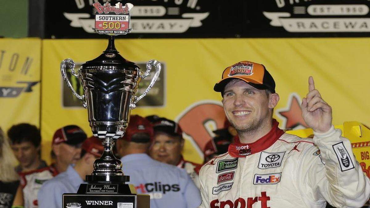 Denny Hamlin poses with his trophy in Victory Lane after winning Sunday’s NASCAR Monster Cup auto race – the Bojangles’ Southern 500 – at Darlington Raceway in Darlington, S.C.