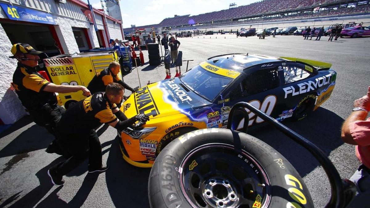 Matt Kenseth’s crew members push his No. 20 Toyota out of the garage for practice Friday at Talladega Superspeedway.