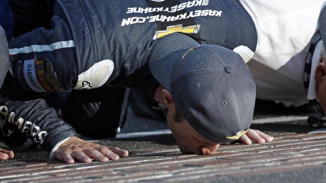 Kasey Kahne kisses the yard of bricks on the start/finish line after winning Sunday’s NASCAR Brickyard 400 auto race at Indianapolis Motor Speedway.