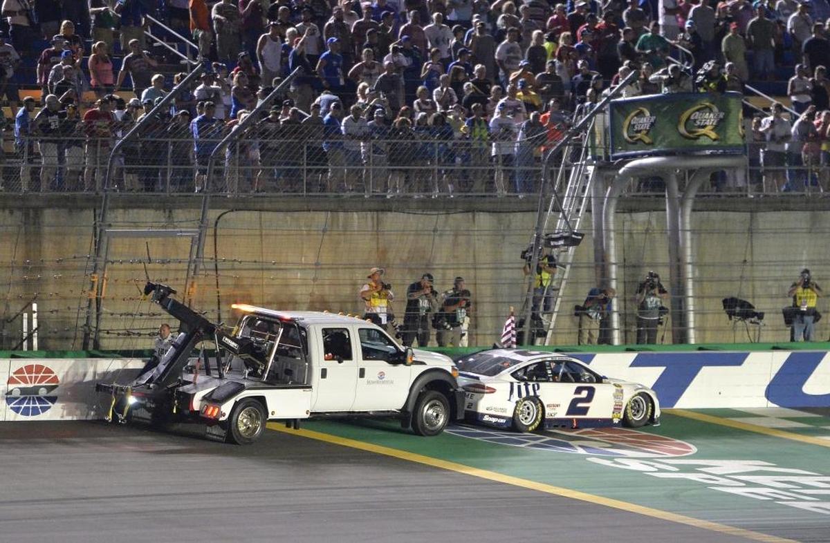 Brad Keselowski’s car is pushed away from the finish line after his victory in last year’s Cup Series race at Kentucky Speedway. Keselowski’s car ran out of gas after the finish.