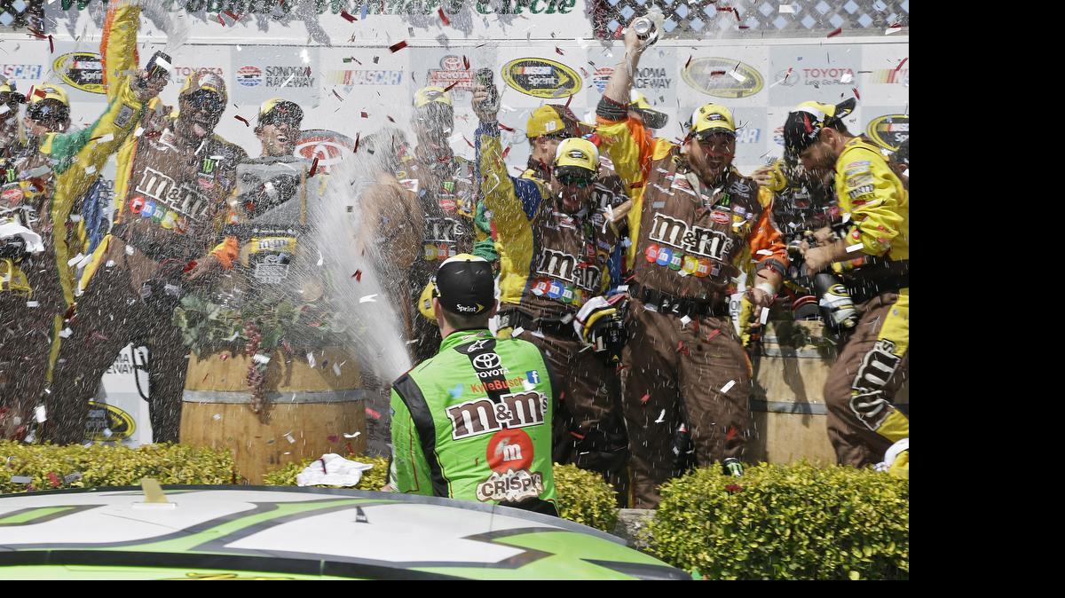 
Kyle Busch sprays his crew after winning the NASCAR Sprint Cup Series auto race Sunday, June 28, 2015, in Sonoma, Calif. 
