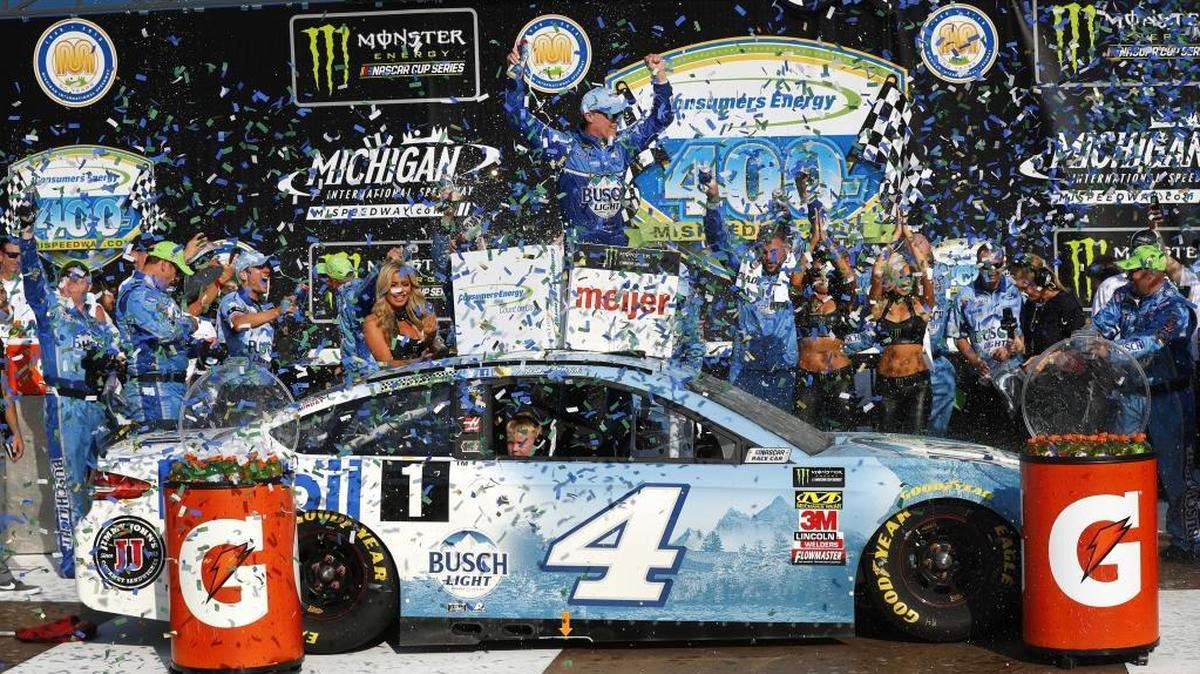 Kevin Harvick celebrates his victory, his seventh of the Cup Series season, in Sunday’s race at Michigan International Speedway as his son, Keelan, sits in the car.