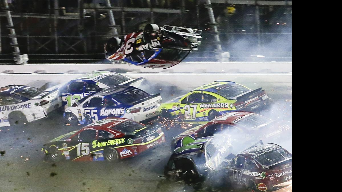 
Austin Dillon (3) goes airborne and hits the catch fence as he was involved in a multi-car crash on the final lap of the NASCAR Sprint Cup series race at Daytona International Speedway early Monday.
